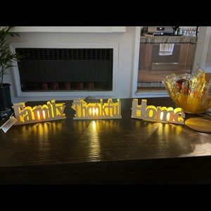 Beautiful table, mantle top lighted wooden signs.